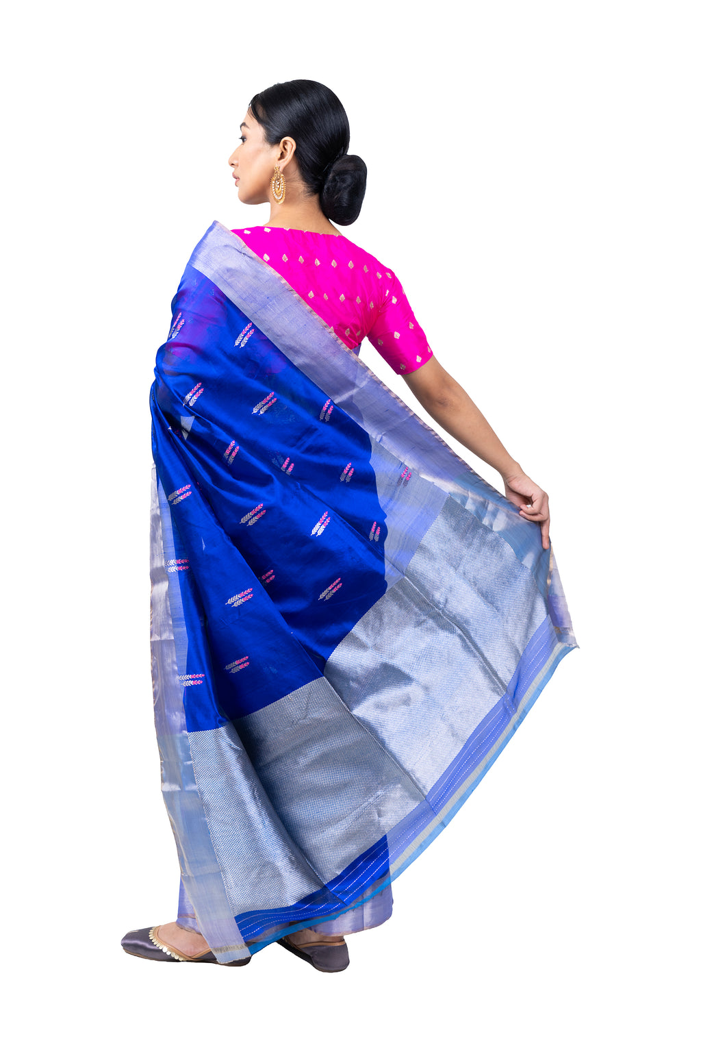 Woman wearing a blue and silver saree with a pink blouse on a white background