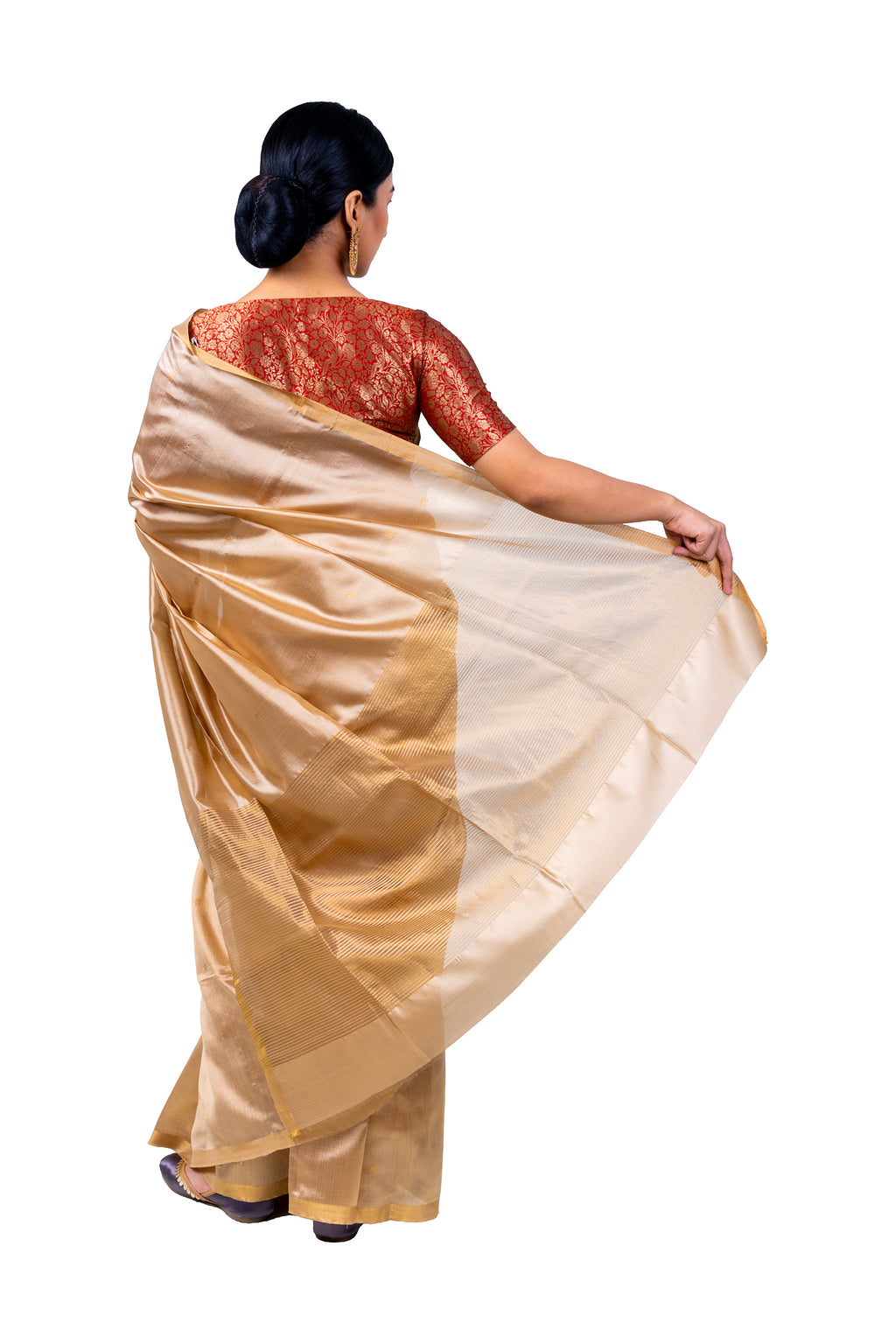 Woman wearing a gold saree with a white blouse on a white background