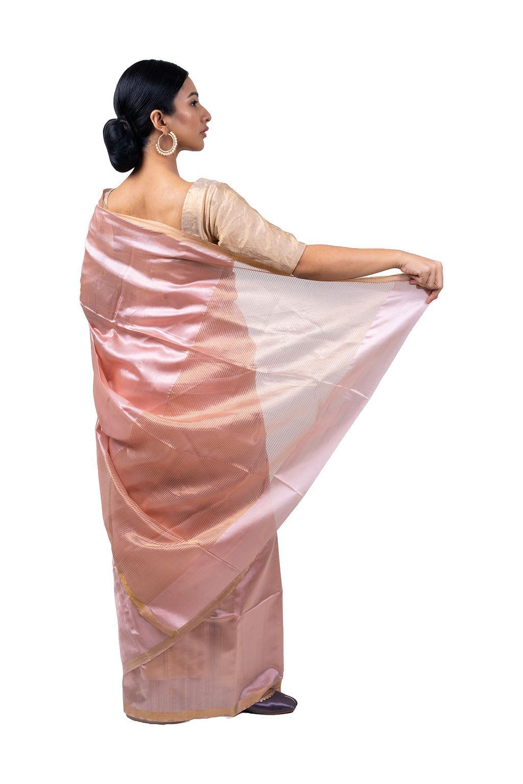 Woman wearing a pink saree with a white background
