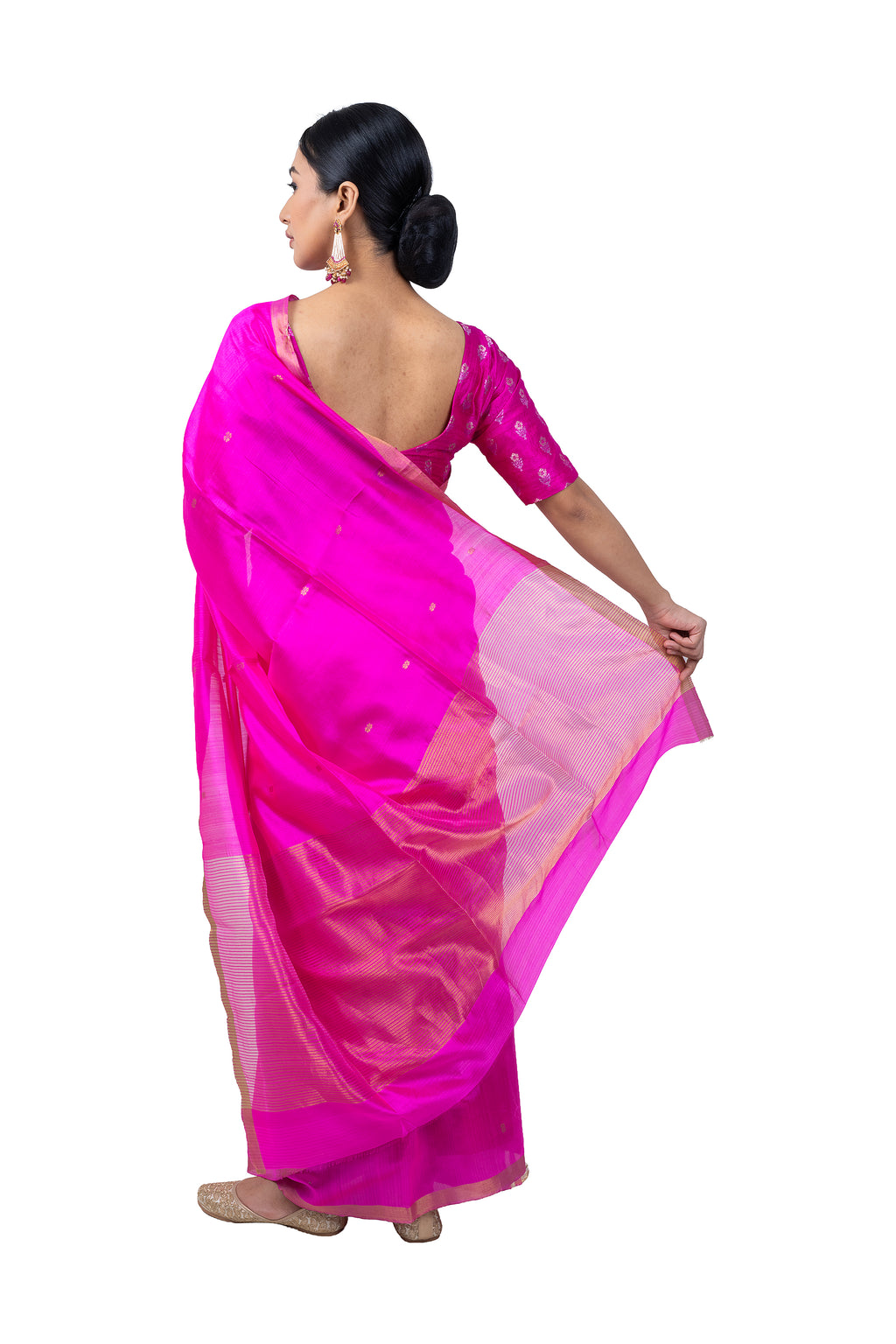 Woman wearing a bright pink saree with a white background