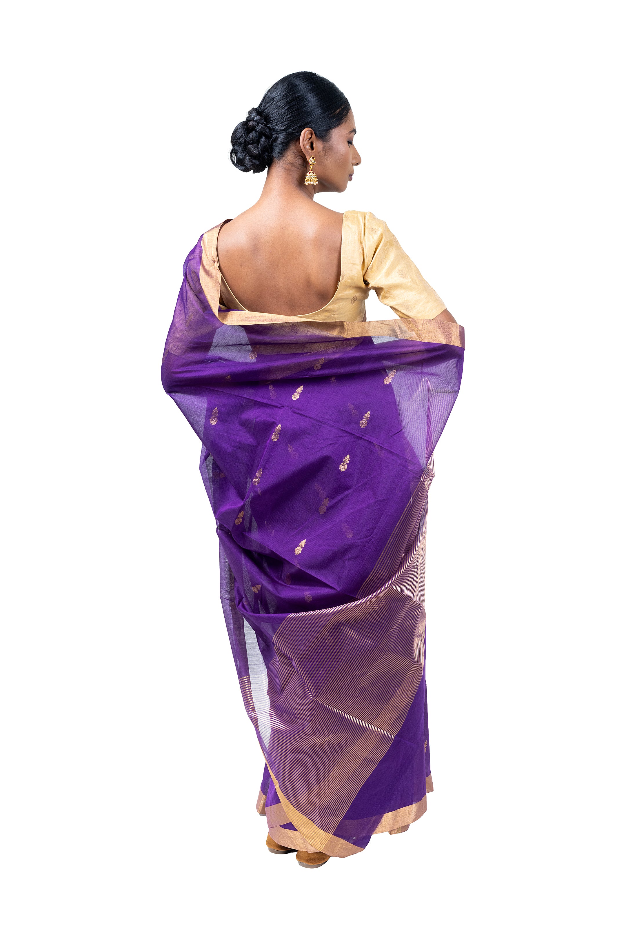 Woman wearing a purple saree with a white background