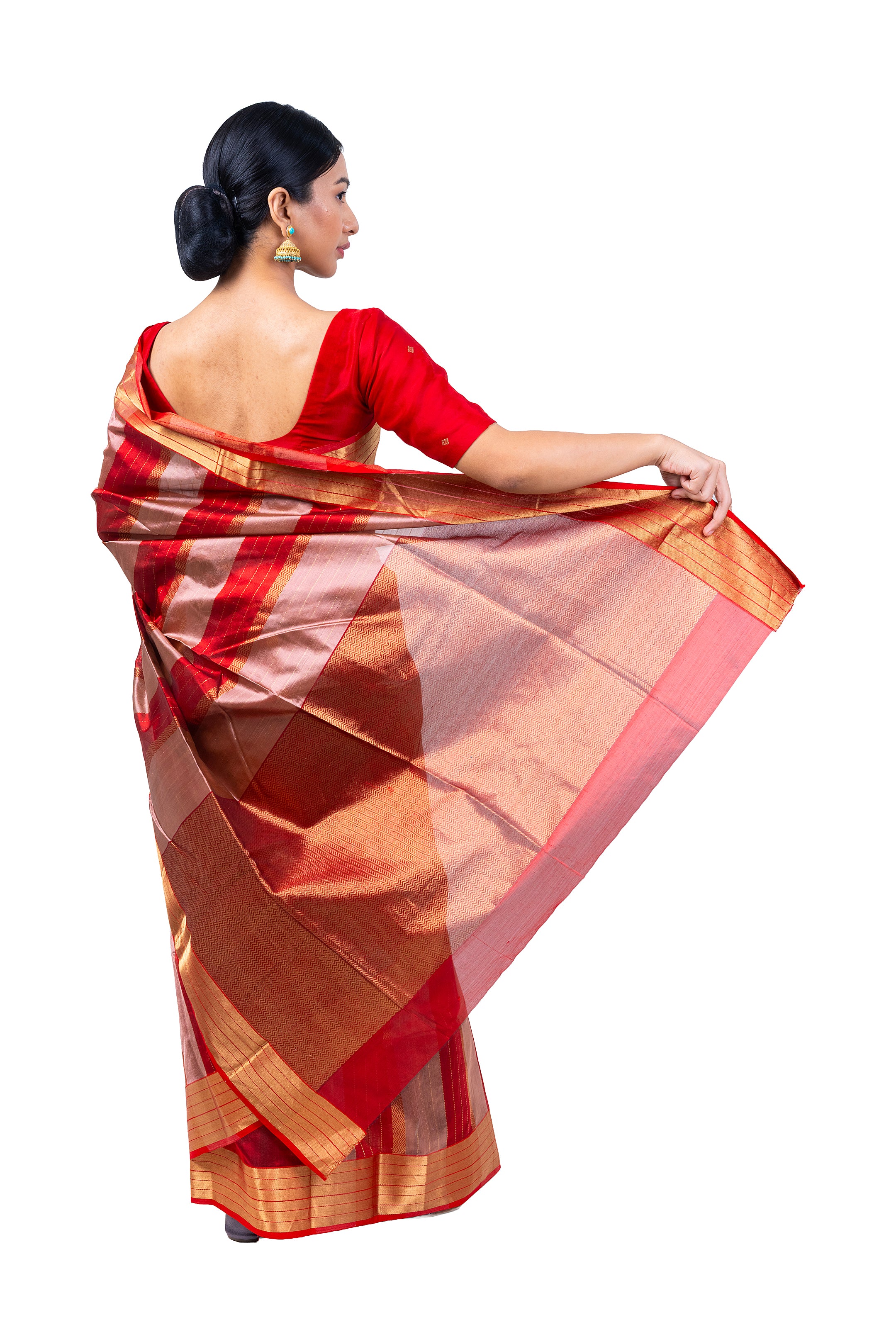 Woman wearing a red and brown saree on a white background