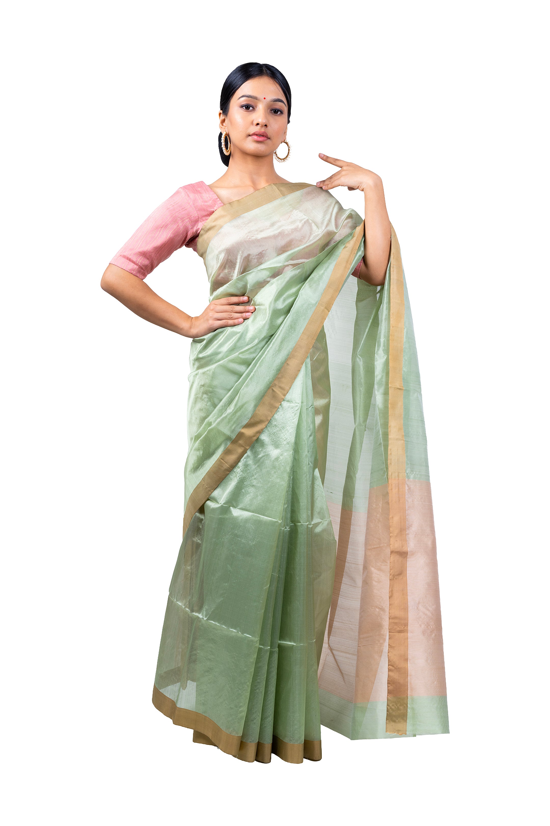 Woman wearing a light green saree with a white blouse on a white background