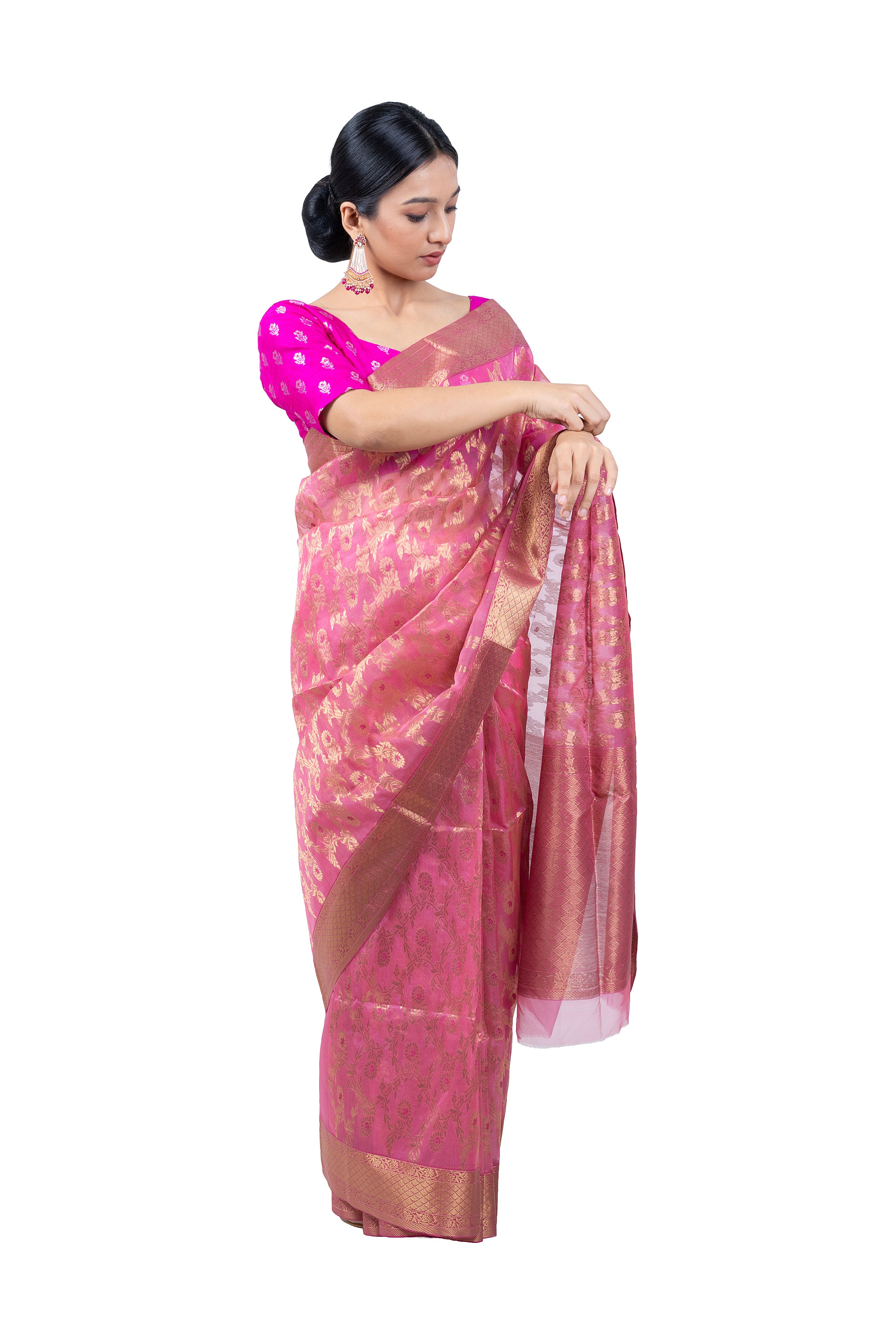 Woman wearing a pink saree with a white background