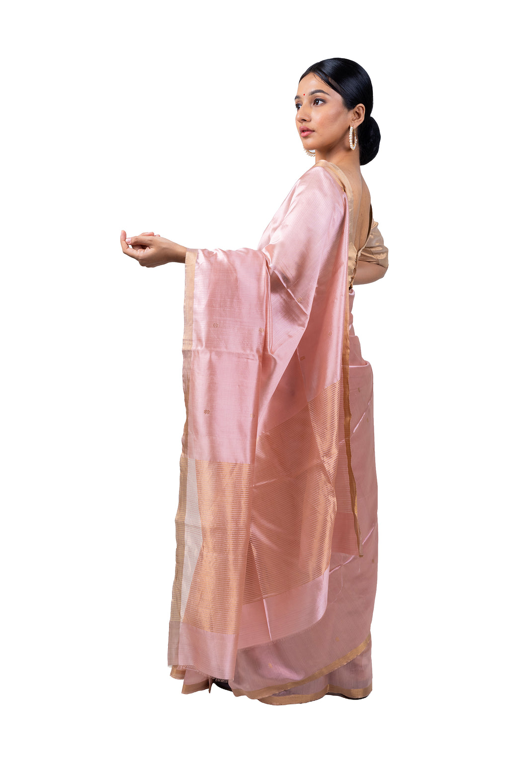 Woman wearing a light pink saree with a white background