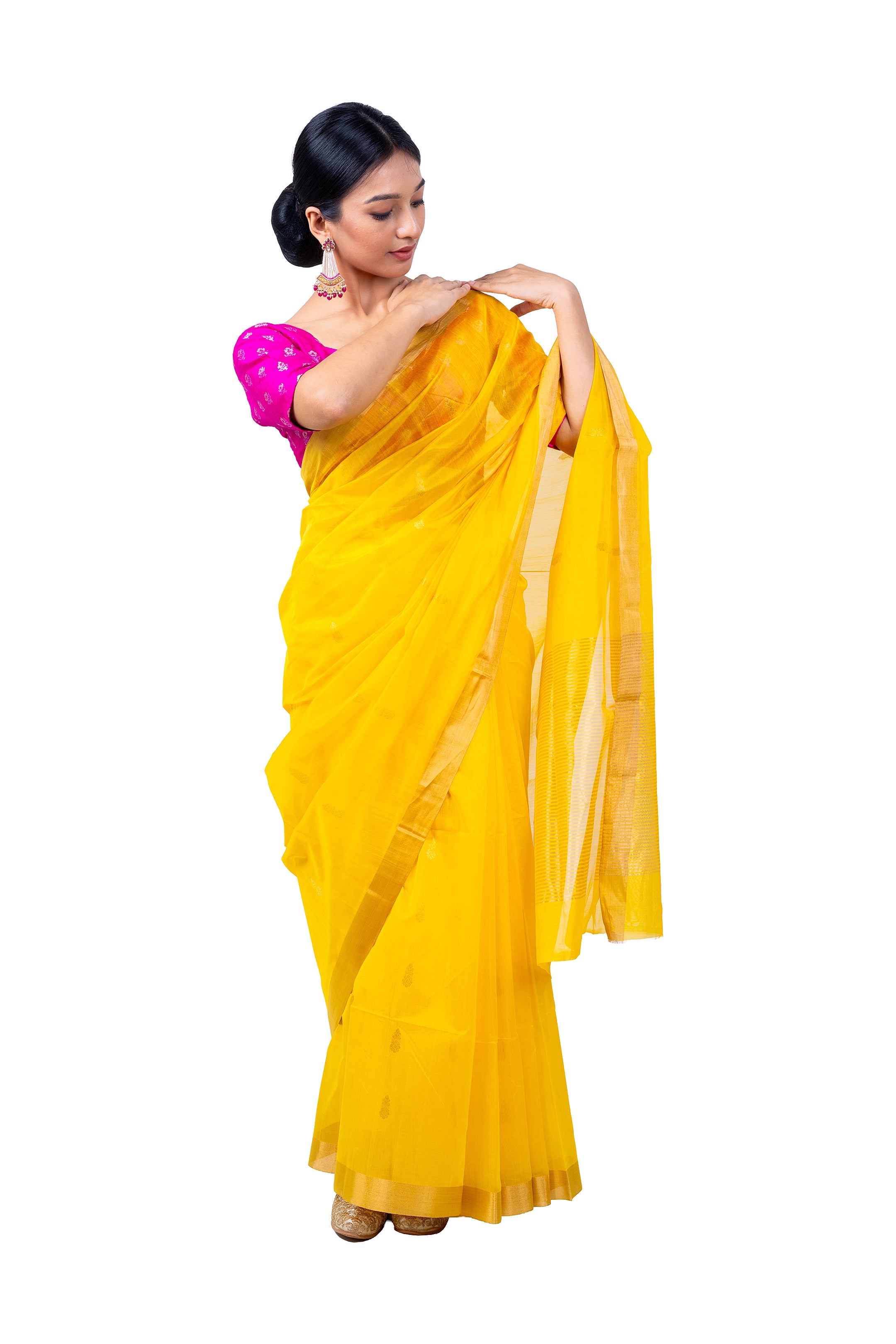 Woman wearing a yellow saree with a pink blouse on a white background