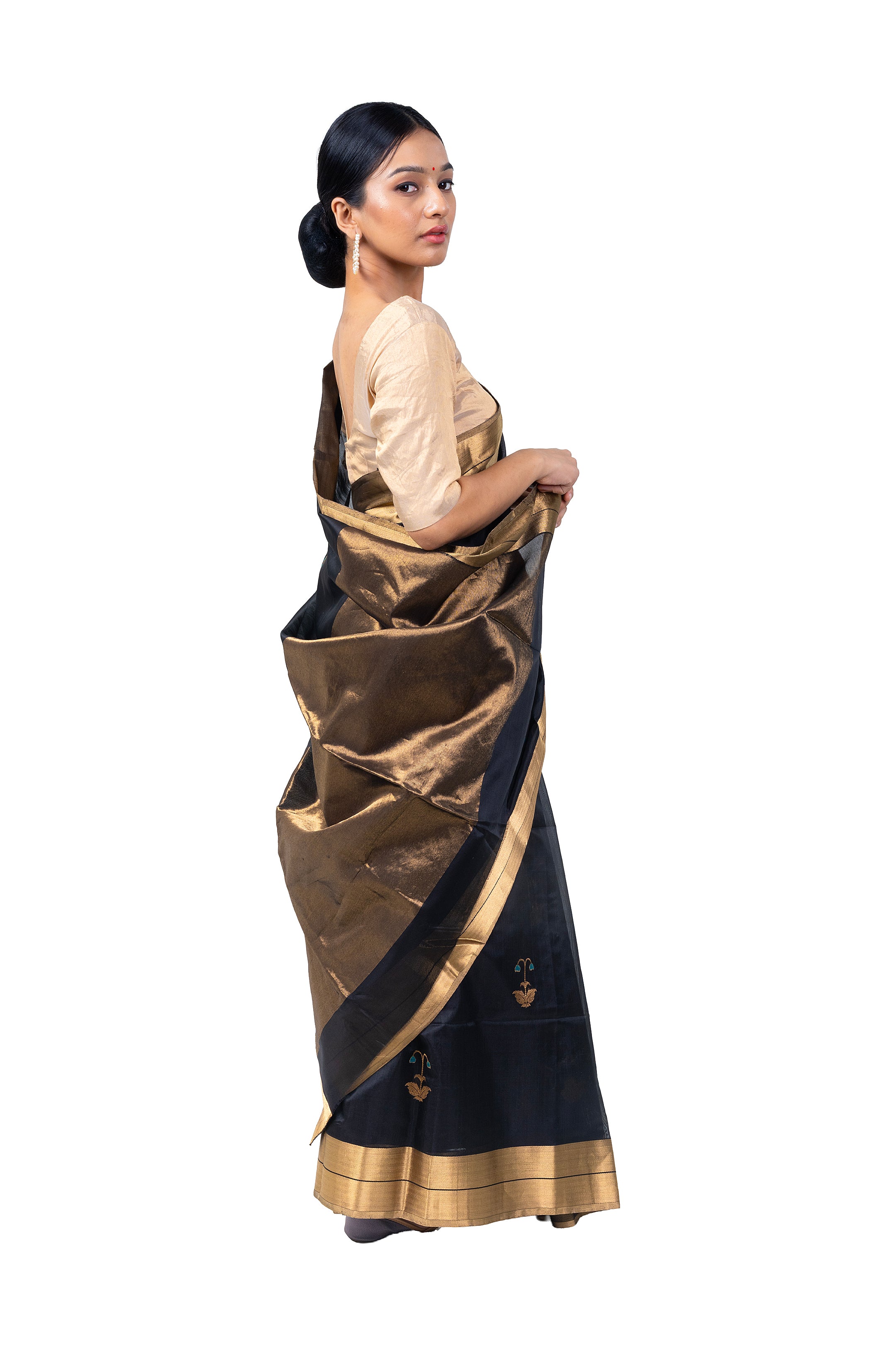 Woman wearing a black and gold saree on a white background