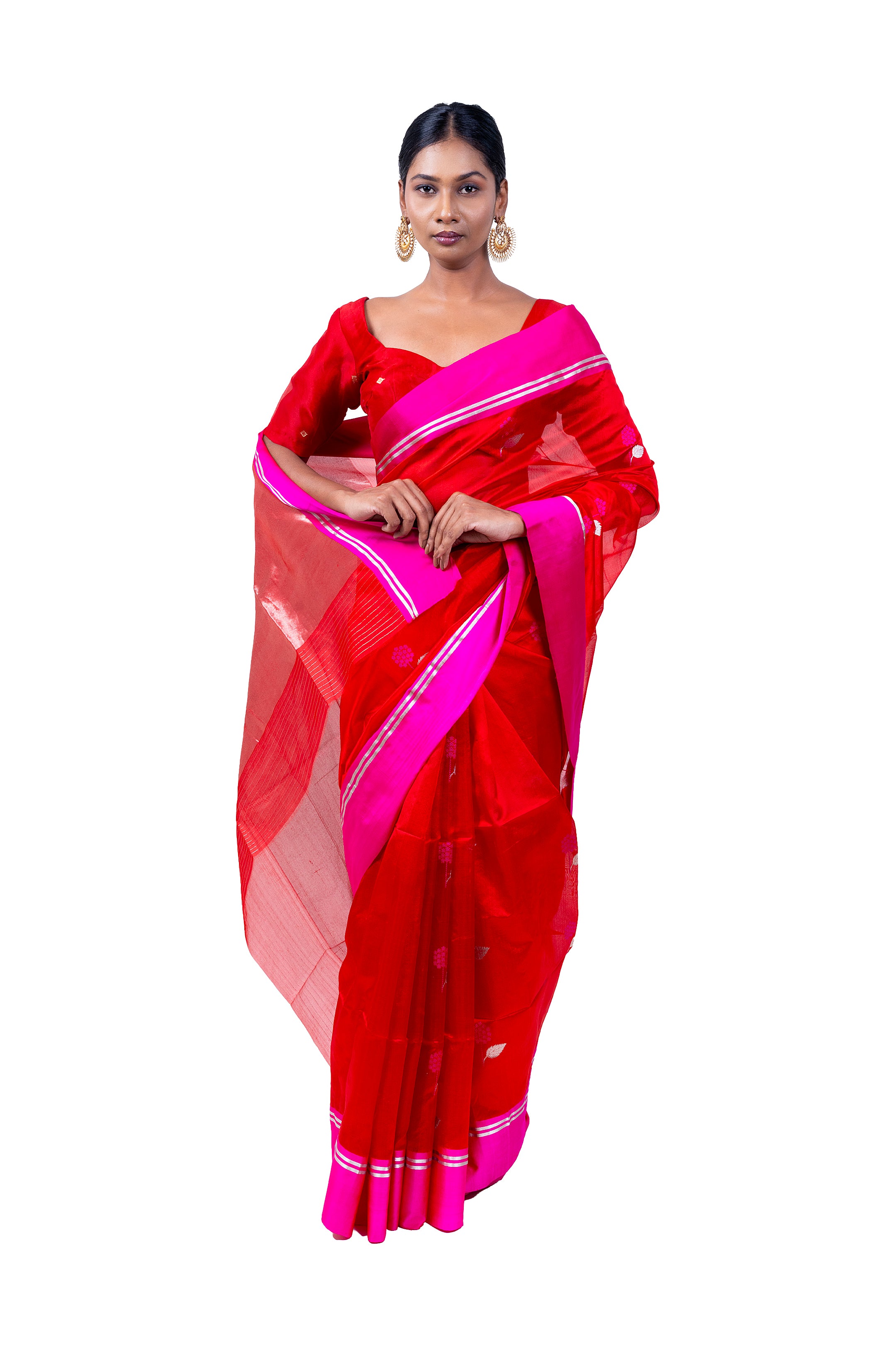 Woman wearing a red saree with pink border on a white background