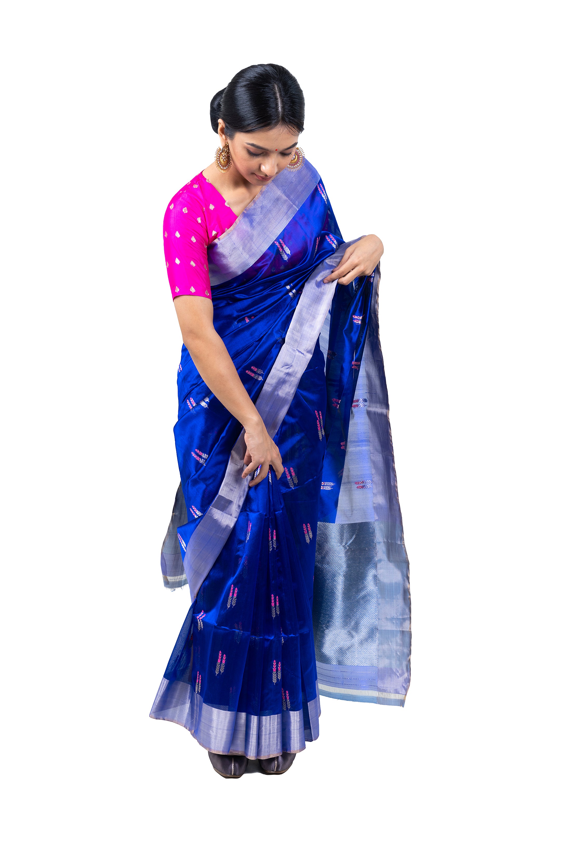 Woman wearing a blue saree with a pink blouse on a white background