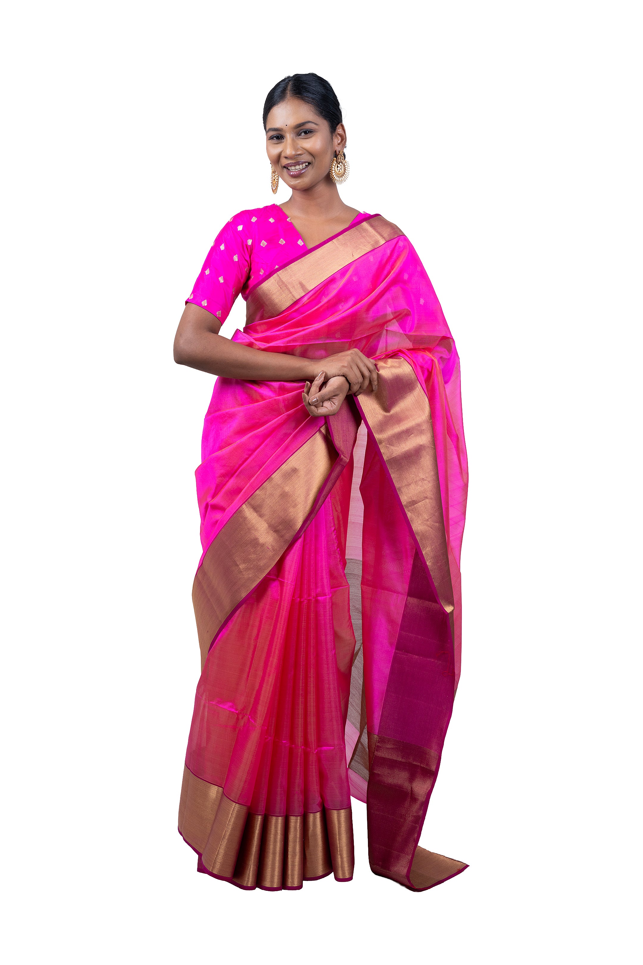 Woman wearing a pink saree with a gold border on a white background