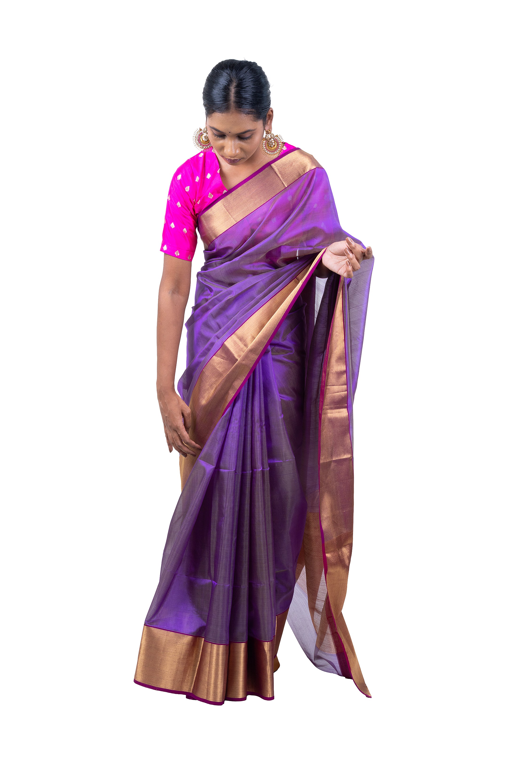 Woman wearing a purple saree with a pink blouse on a white background