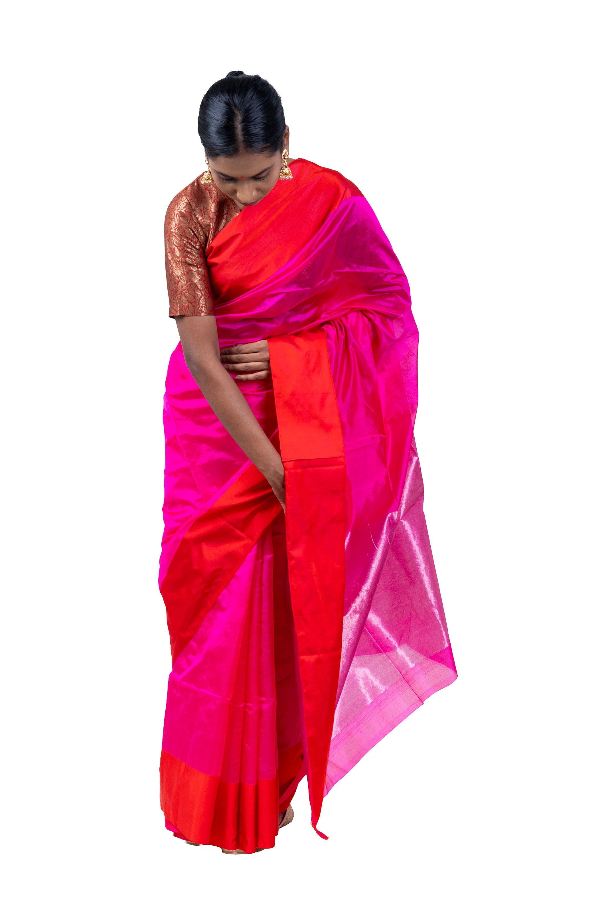 Woman wearing a bright pink and orange saree on a white background