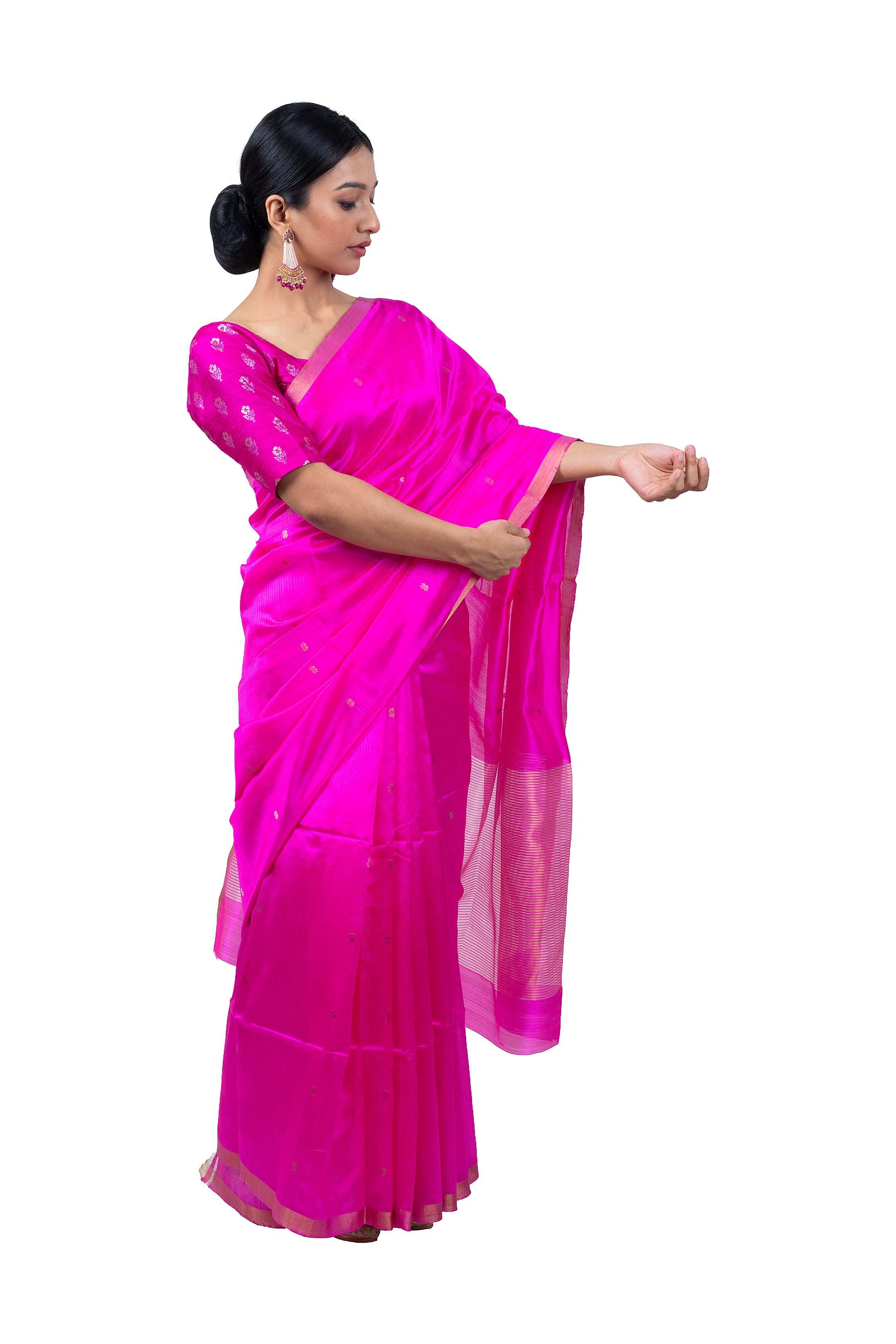 Woman wearing a bright pink saree with a white background