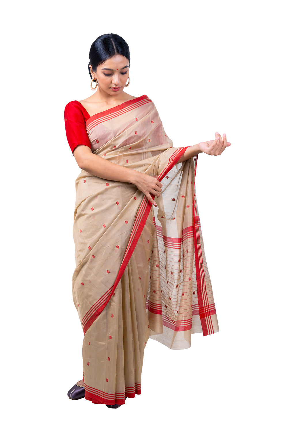 Woman wearing a beige saree with red accents on a white background