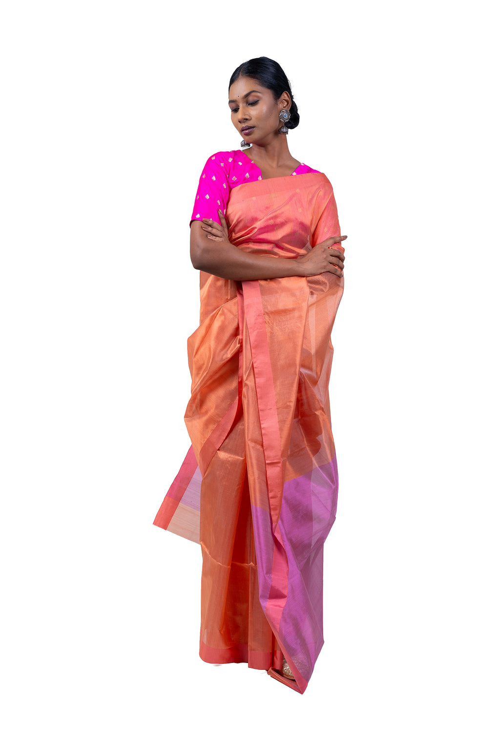 Woman wearing a peach saree with pink blouse on a white background