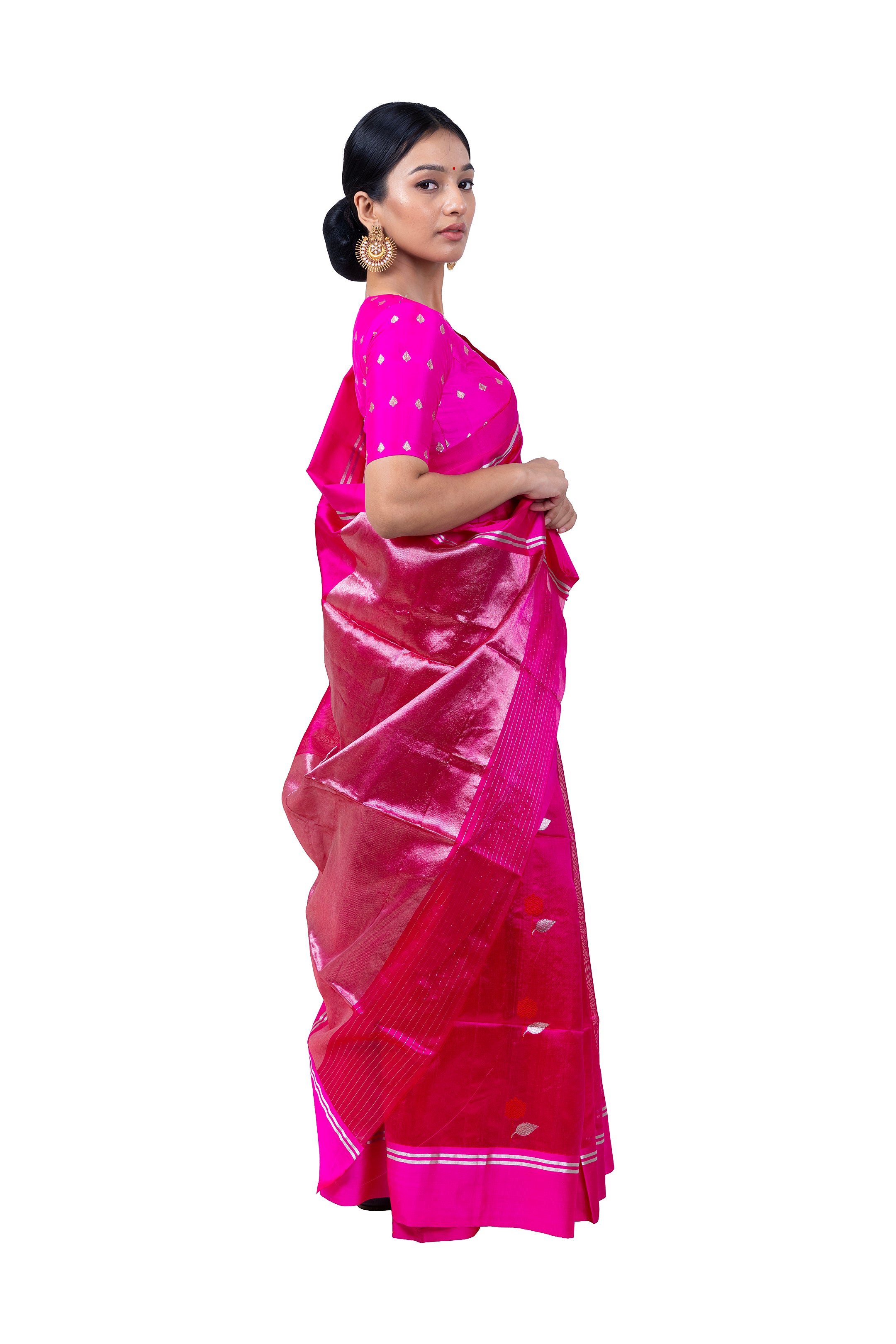 Woman wearing a bright pink saree with a white border on a white background