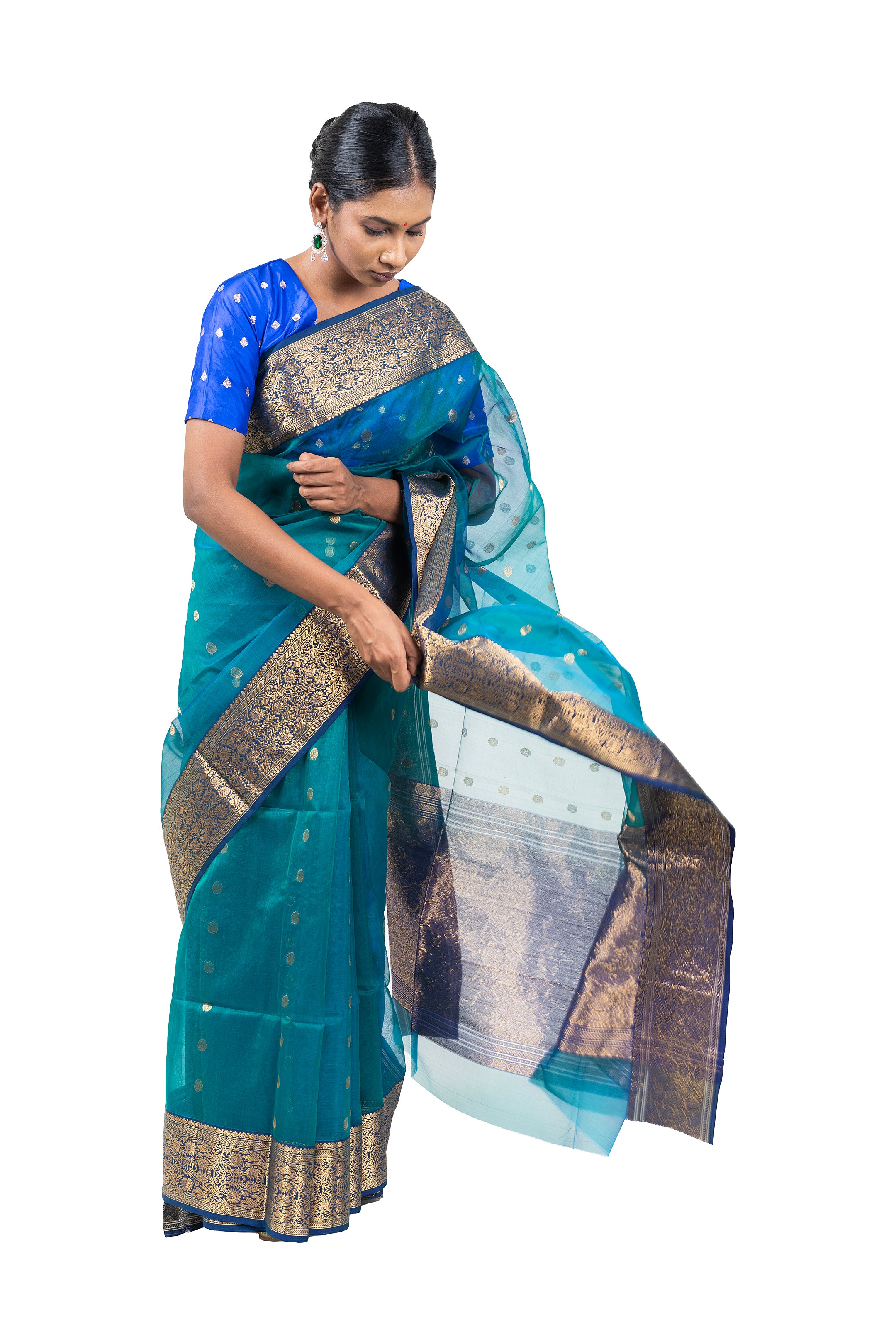 Woman wearing a blue and green saree with a white background