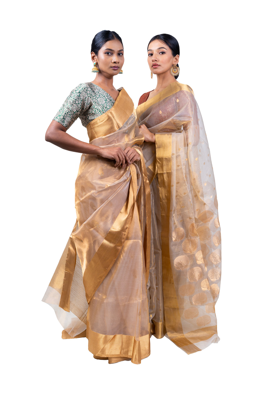 Two women wearing gold sarees with white blouse on a white background