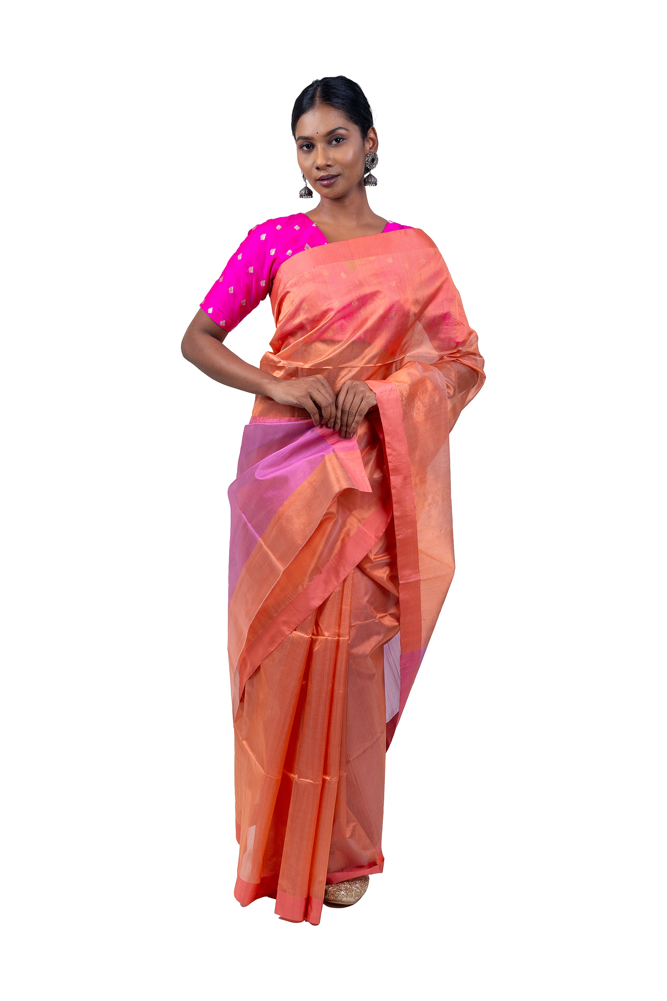Woman wearing a peach saree with pink blouse on a white background