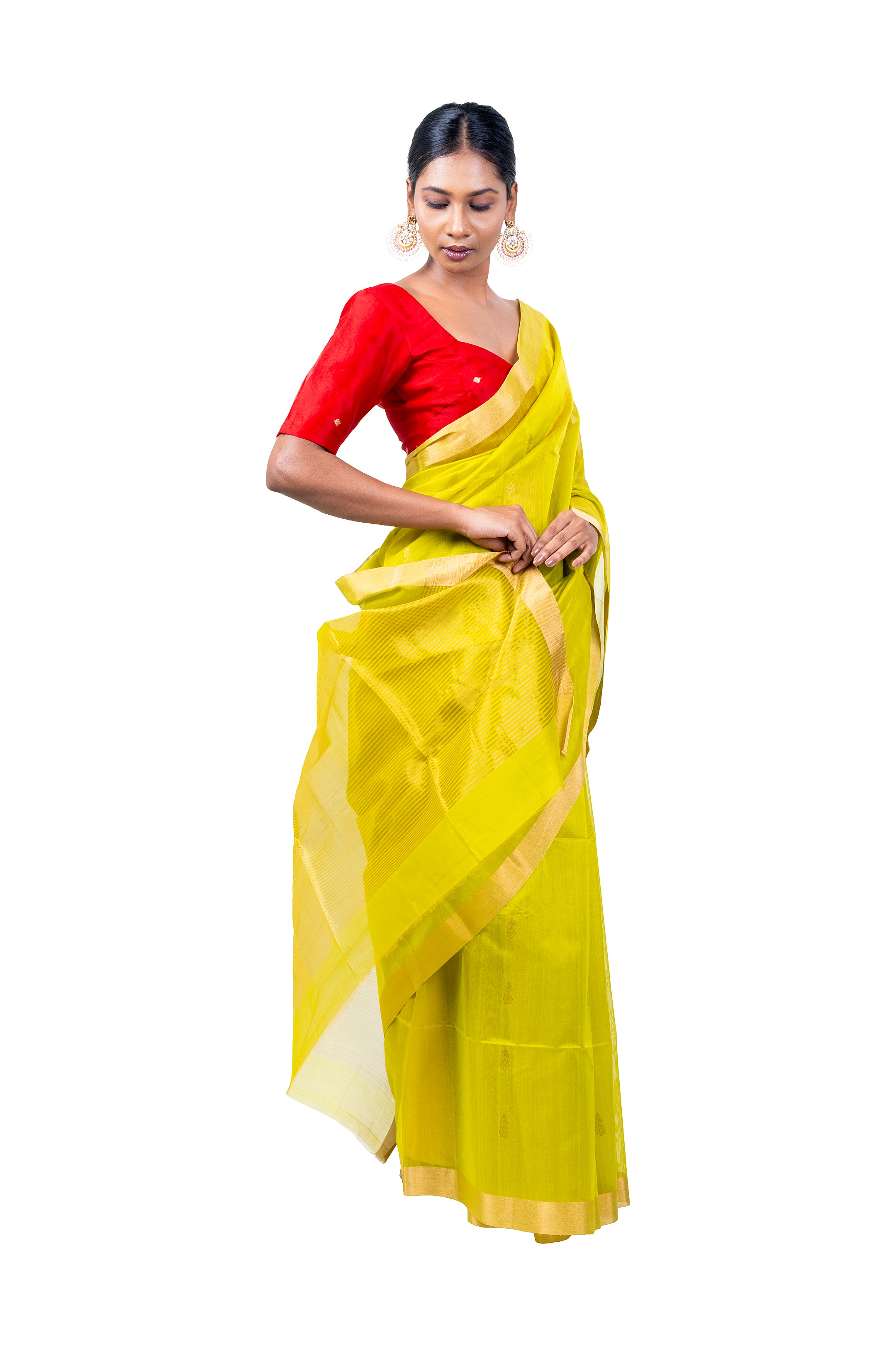Woman wearing a yellow saree with a red blouse on a white background