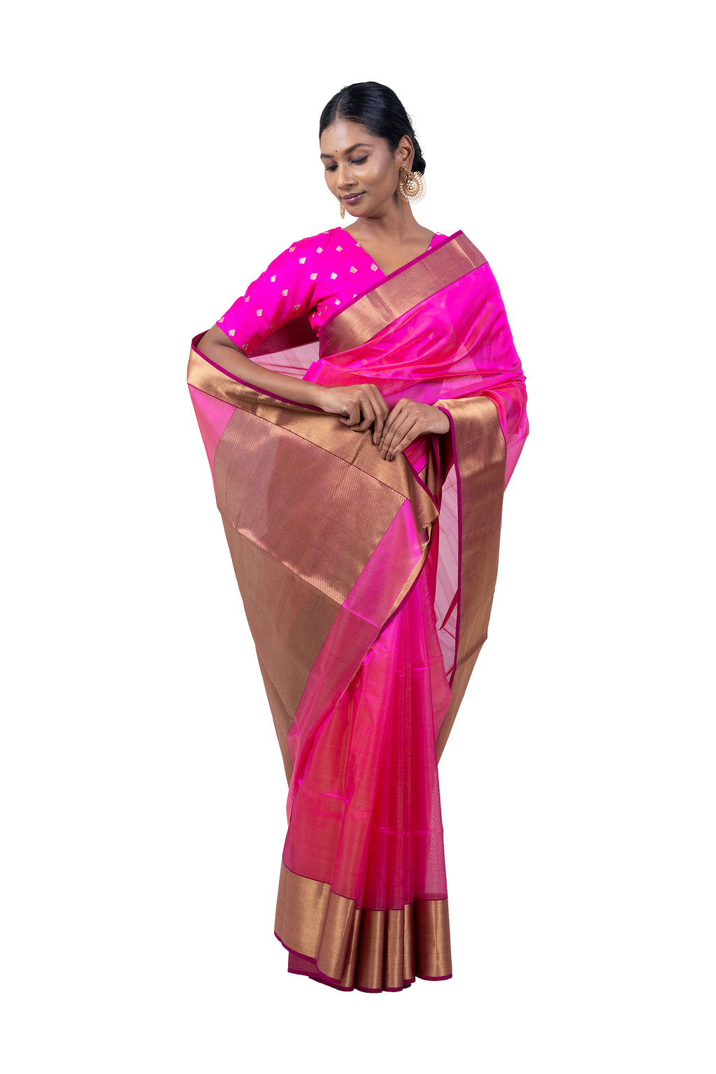 Woman wearing a pink saree with a gold border on a white background