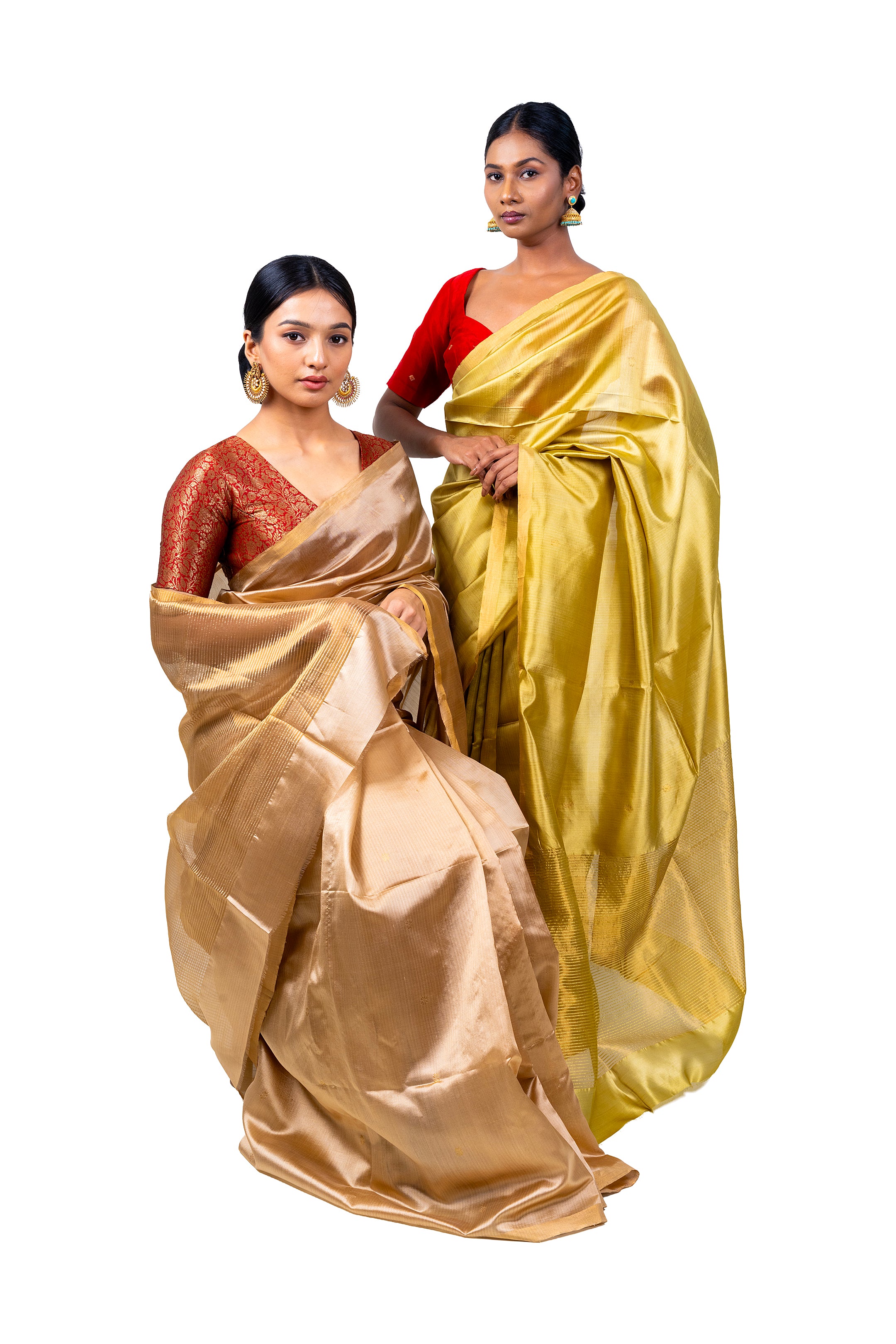 Two women wearing traditional sarees on a white background